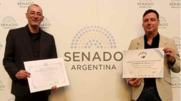 Los profesores Cristian Anghilante y Miguel Frutos recibiendo un reconocimiento para el Coro de Coronda